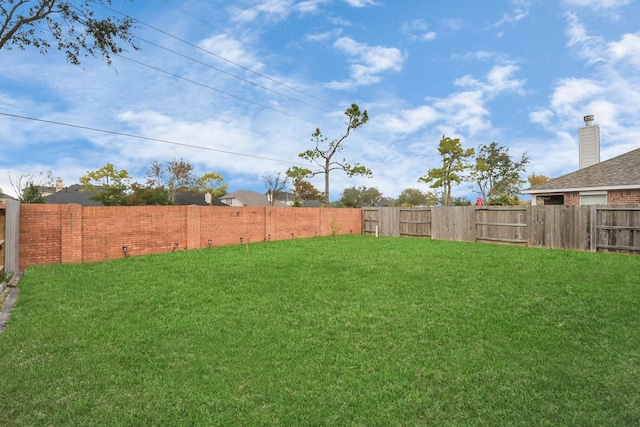 view of yard with a fenced backyard