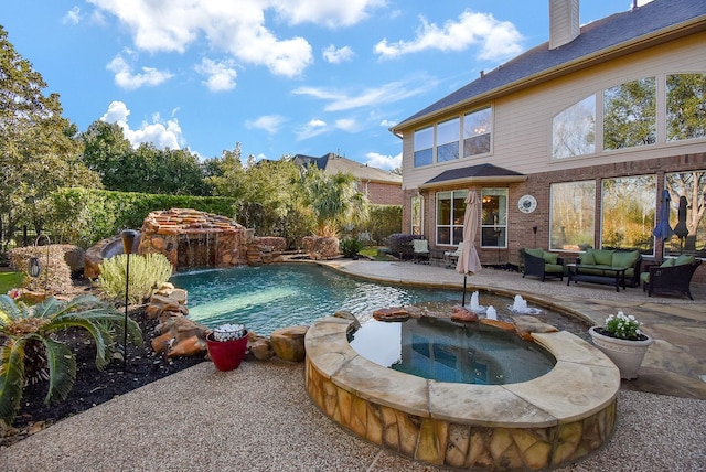 outdoor pool with a patio and an outdoor hangout area