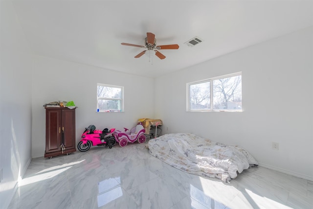 bedroom with marble finish floor, visible vents, ceiling fan, and baseboards