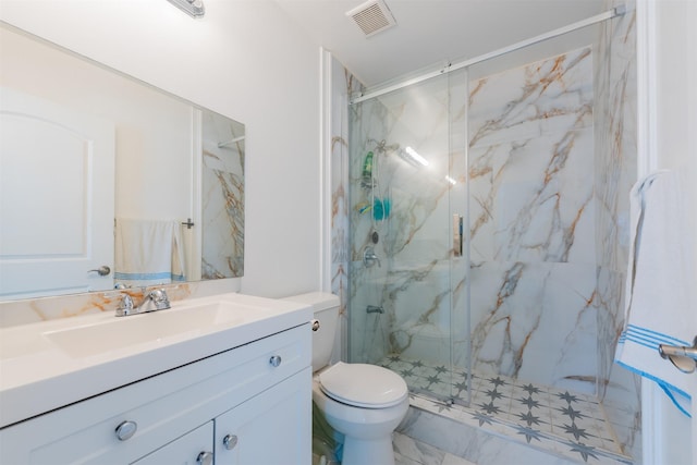 bathroom with visible vents, toilet, vanity, and a marble finish shower