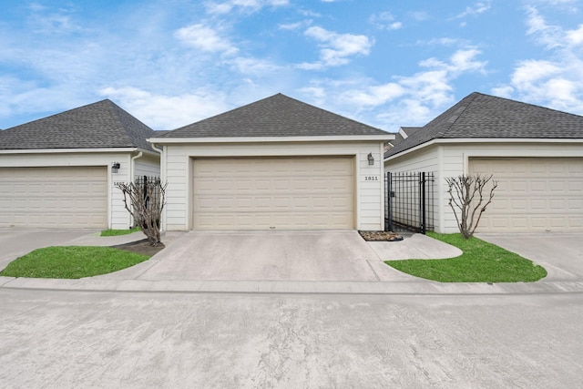 ranch-style home with fence and roof with shingles