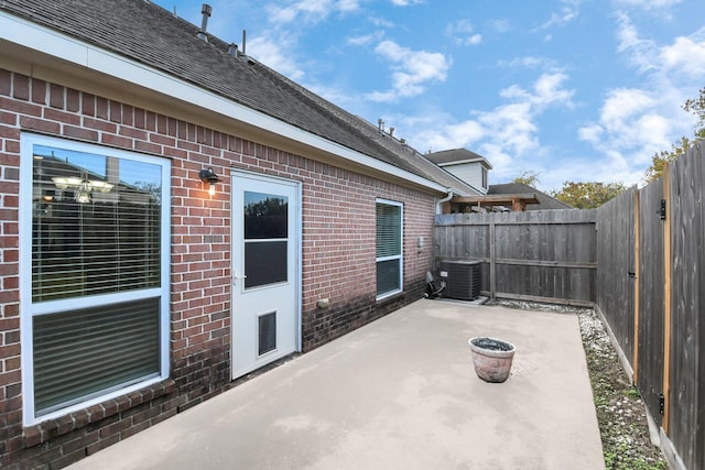 view of patio with central air condition unit and a fenced backyard