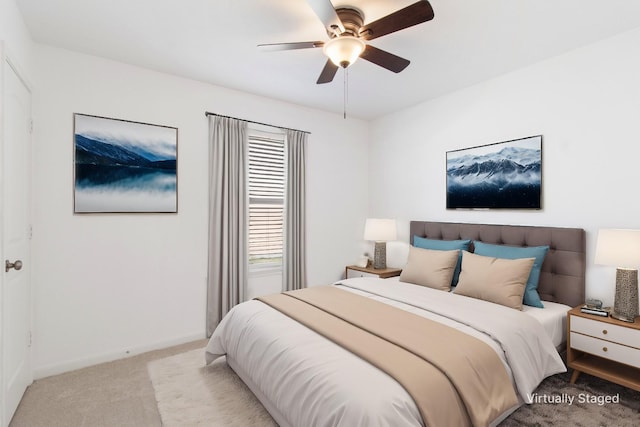 carpeted bedroom featuring ceiling fan and baseboards