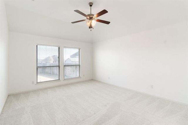 carpeted empty room featuring a ceiling fan and lofted ceiling