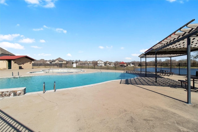 pool with a patio and fence