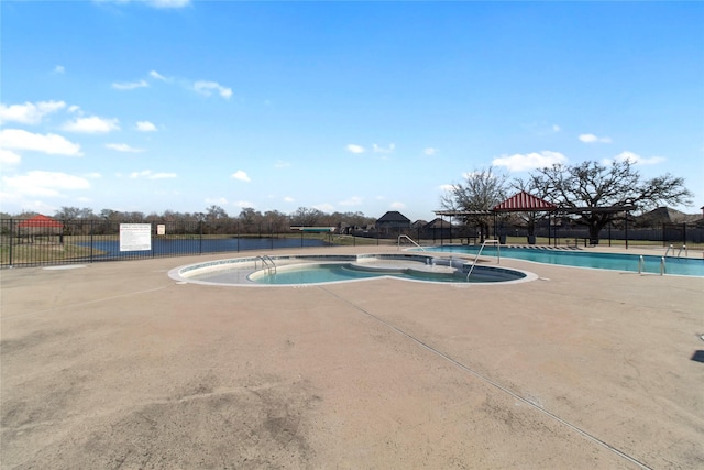 community pool with fence and a gazebo