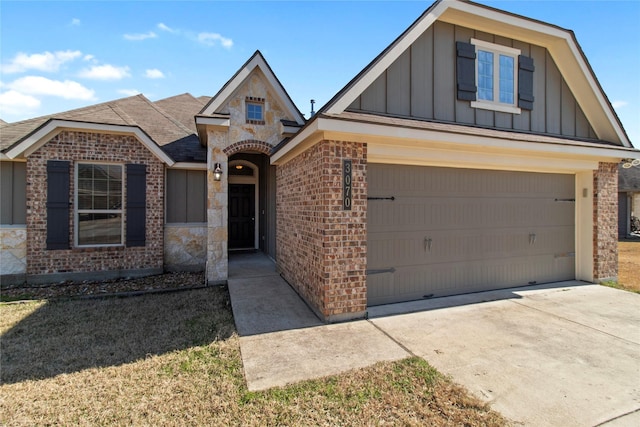 view of front of home featuring driveway, stone siding, board and batten siding, and brick siding