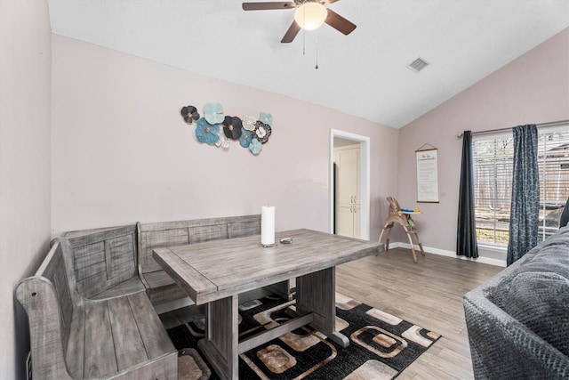 interior space featuring lofted ceiling, ceiling fan, visible vents, baseboards, and light wood-type flooring