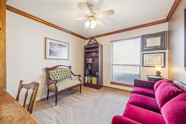 living area with carpet floors, baseboards, ornamental molding, and ceiling fan