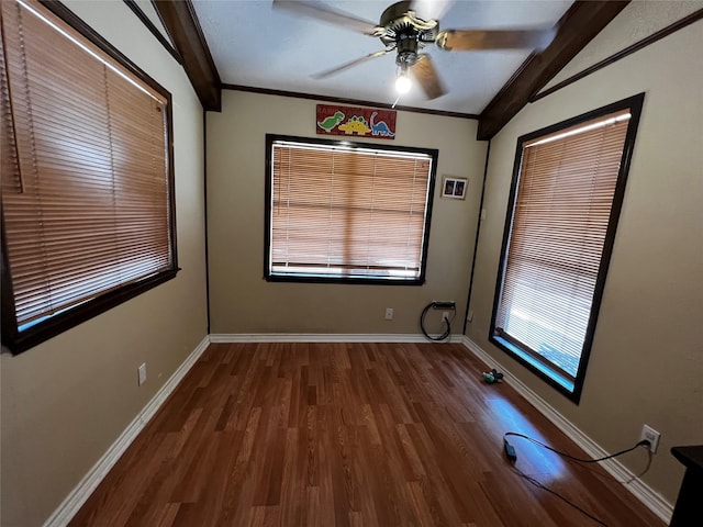 empty room with a ceiling fan, crown molding, baseboards, and wood finished floors