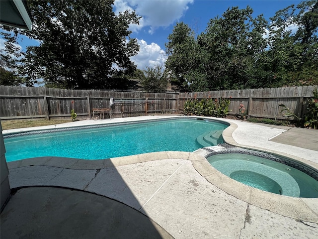 view of pool with a patio area, a fenced backyard, and a pool with connected hot tub