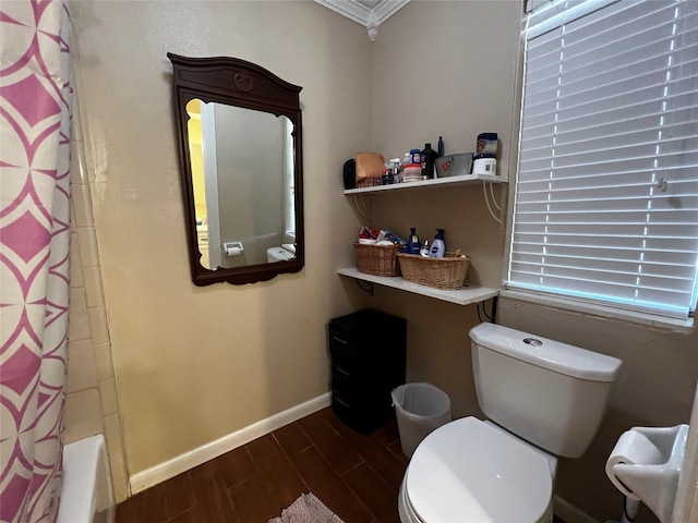 bathroom featuring baseboards, toilet, and wood tiled floor