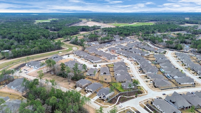 drone / aerial view featuring a forest view and a residential view