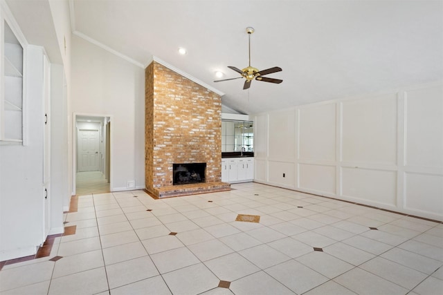 unfurnished living room with light tile patterned floors, ceiling fan, ornamental molding, a fireplace, and a decorative wall