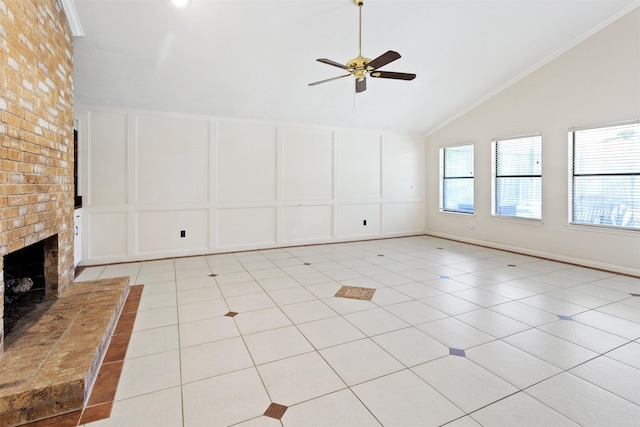 unfurnished living room featuring ceiling fan, high vaulted ceiling, light tile patterned flooring, a decorative wall, and a brick fireplace