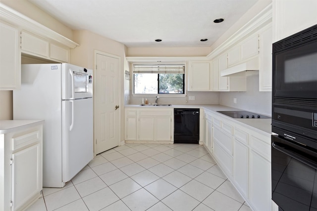 kitchen featuring light countertops, a sink, and black appliances