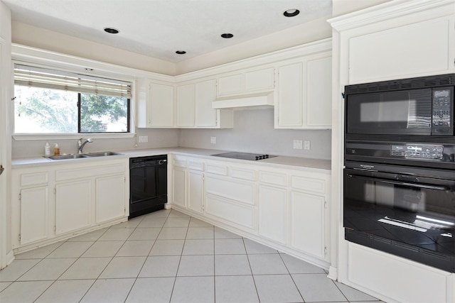 kitchen featuring light tile patterned flooring, under cabinet range hood, a sink, white cabinets, and black appliances