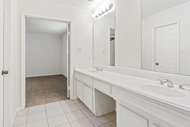 full bathroom with double vanity, ornamental molding, a sink, and tile patterned floors