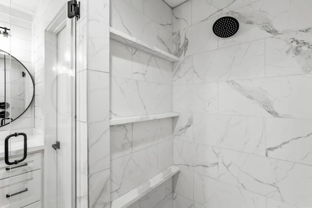 bathroom featuring a marble finish shower