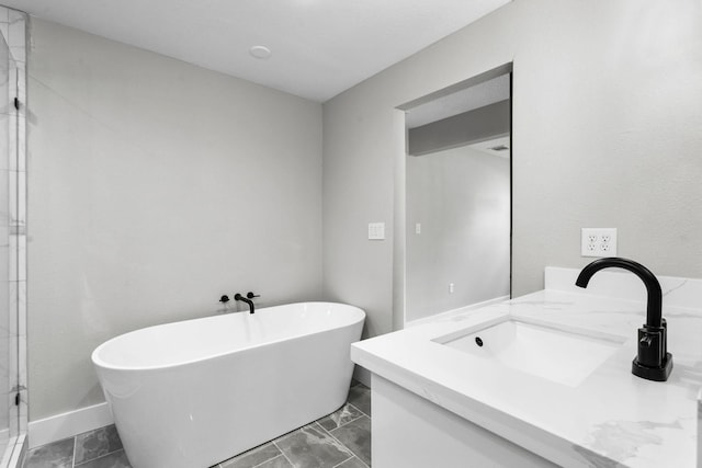 full bathroom with a freestanding tub, a shower stall, and vanity