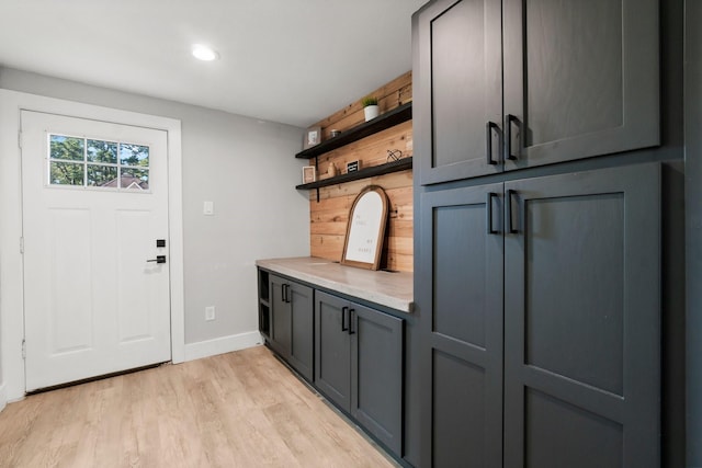 mudroom with light wood-style flooring and baseboards