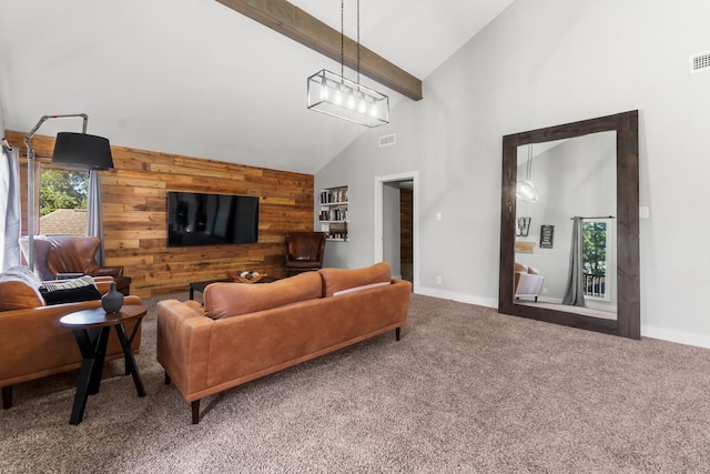 living area with high vaulted ceiling, wooden walls, carpet flooring, visible vents, and beamed ceiling