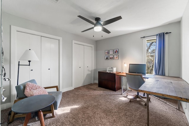 office with a ceiling fan and carpet flooring