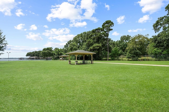 view of property's community with a water view, a yard, and a gazebo