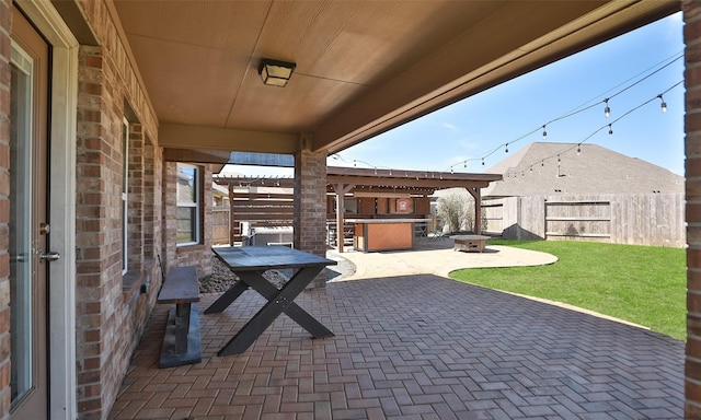 view of patio / terrace with an outdoor fire pit and fence