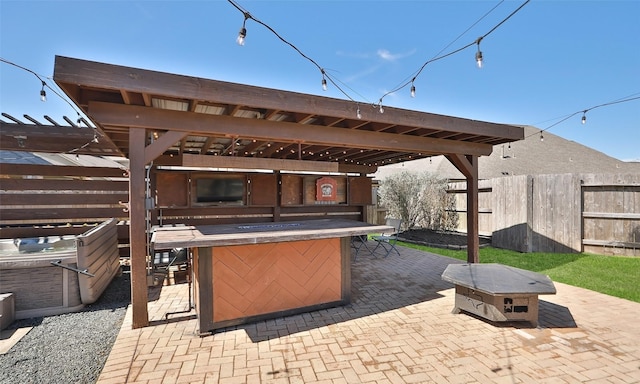 view of patio / terrace featuring fence and outdoor dry bar