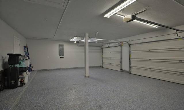 garage with electric panel and a garage door opener