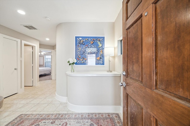 corridor with recessed lighting, visible vents, baseboards, and light tile patterned floors