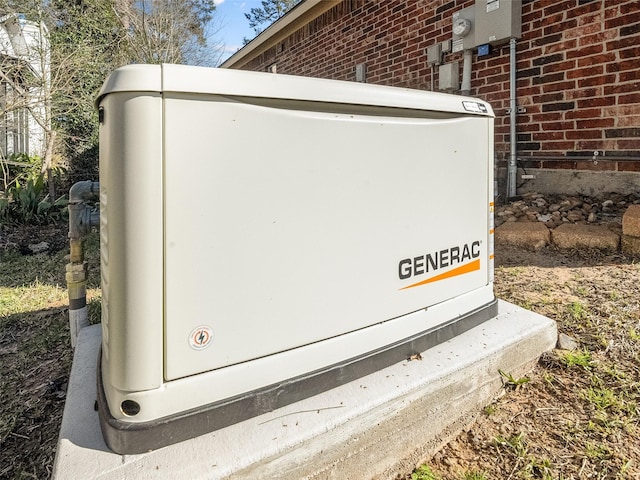 details with brick siding, a power unit, and electric meter