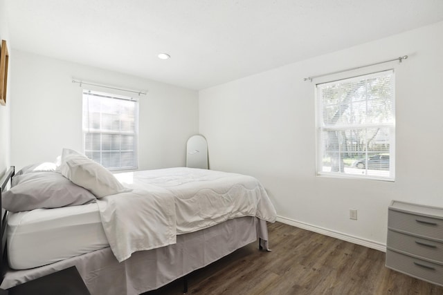 bedroom featuring wood finished floors, multiple windows, baseboards, and recessed lighting