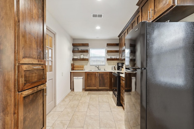 kitchen featuring black appliances, open shelves, light countertops, recessed lighting, and a sink