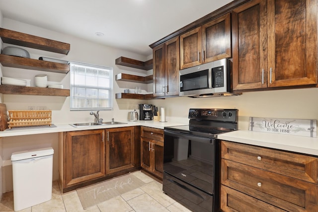 kitchen featuring stainless steel microwave, open shelves, black electric range oven, a sink, and light countertops