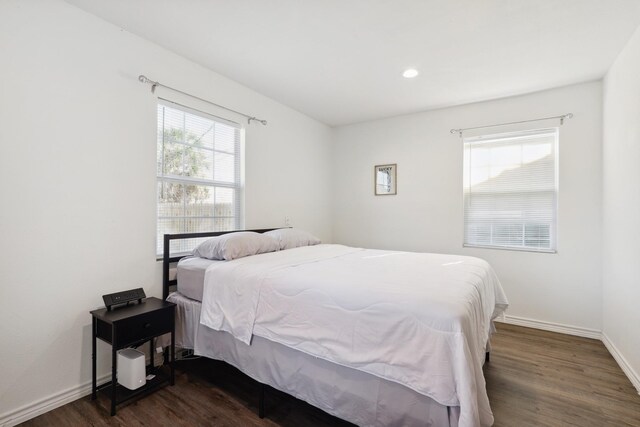 bedroom featuring dark wood-type flooring, baseboards, and recessed lighting