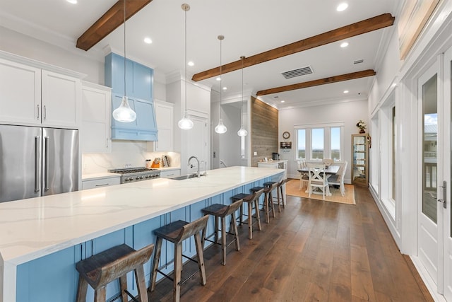 kitchen featuring dark wood-style flooring, french doors, beam ceiling, a spacious island, and high end refrigerator