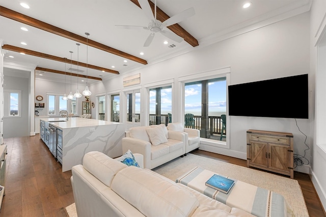 living room featuring a ceiling fan, recessed lighting, wood-type flooring, and beamed ceiling