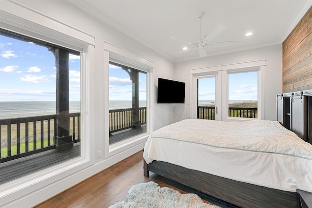 bedroom featuring dark wood-style floors, access to outside, crown molding, and recessed lighting