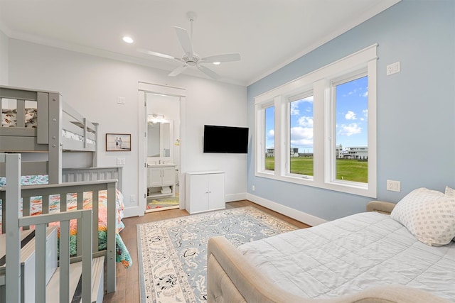 bedroom featuring crown molding, baseboards, wood finished floors, and recessed lighting