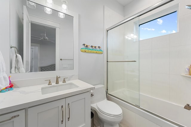 full bath with enclosed tub / shower combo, vanity, and toilet