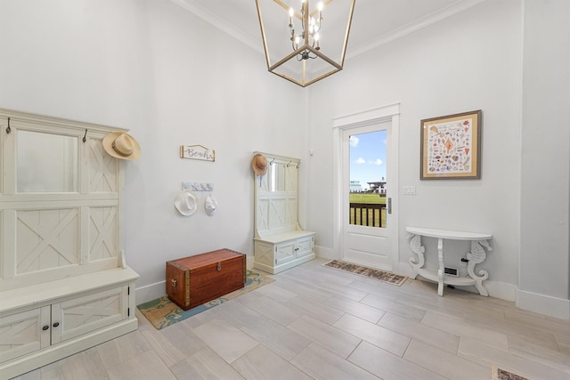 mudroom featuring a notable chandelier, ornamental molding, and baseboards