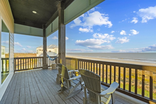 wooden terrace with a water view and a beach view