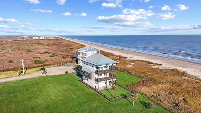 drone / aerial view with a water view and a beach view