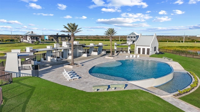 community pool featuring fence, a patio, and a lawn