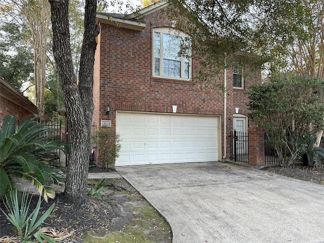 view of property exterior featuring a garage, fence, concrete driveway, and brick siding