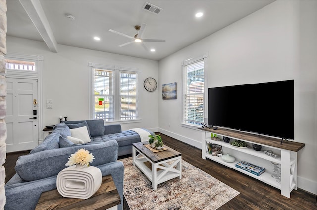 living room featuring a healthy amount of sunlight, visible vents, dark wood-type flooring, and recessed lighting