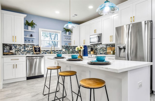 kitchen with white cabinetry, visible vents, appliances with stainless steel finishes, and open shelves