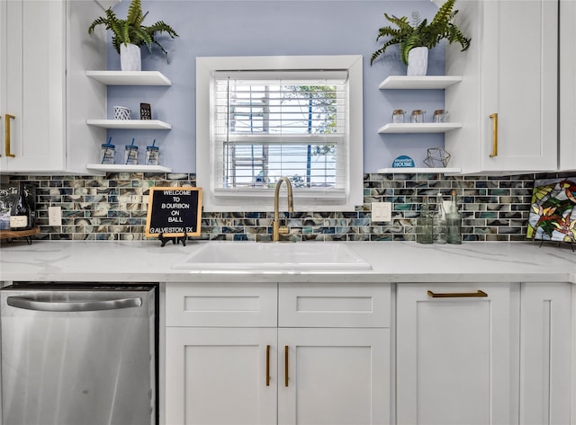 kitchen with open shelves, stainless steel dishwasher, a sink, and white cabinets